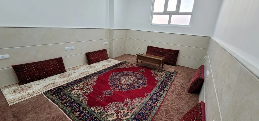 A traditionally styled SIOS study room with Persian carpets, floor cushions and armrests arranged around the walls