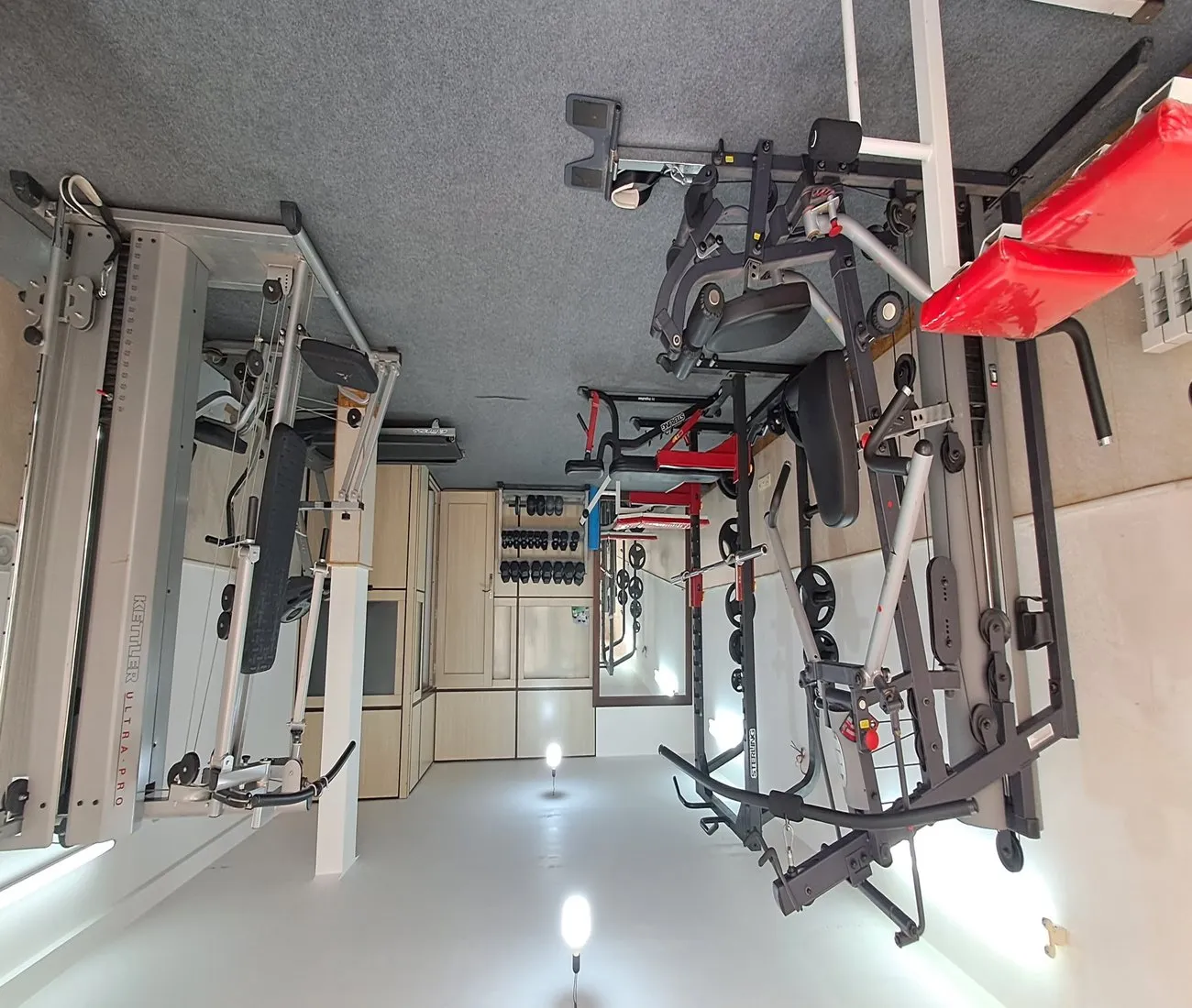 The SIOS gym on the ground floor of the dormitory, fitted with free weights, multi-function workout stations, a power rack and a treadmill