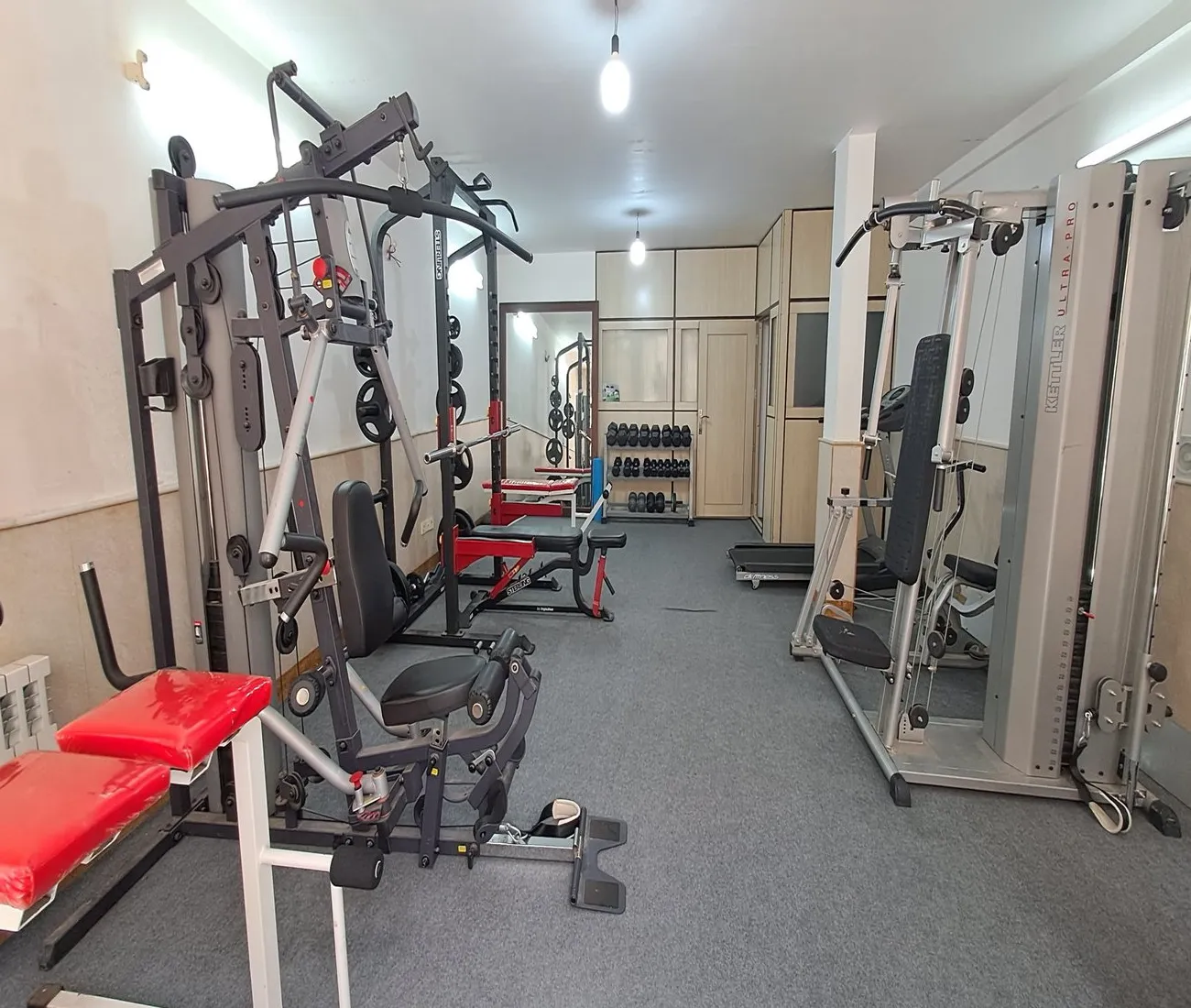 The SIOS gym on the ground floor of the dormitory, fitted with free weights, multi-function workout stations, a power rack and a treadmill